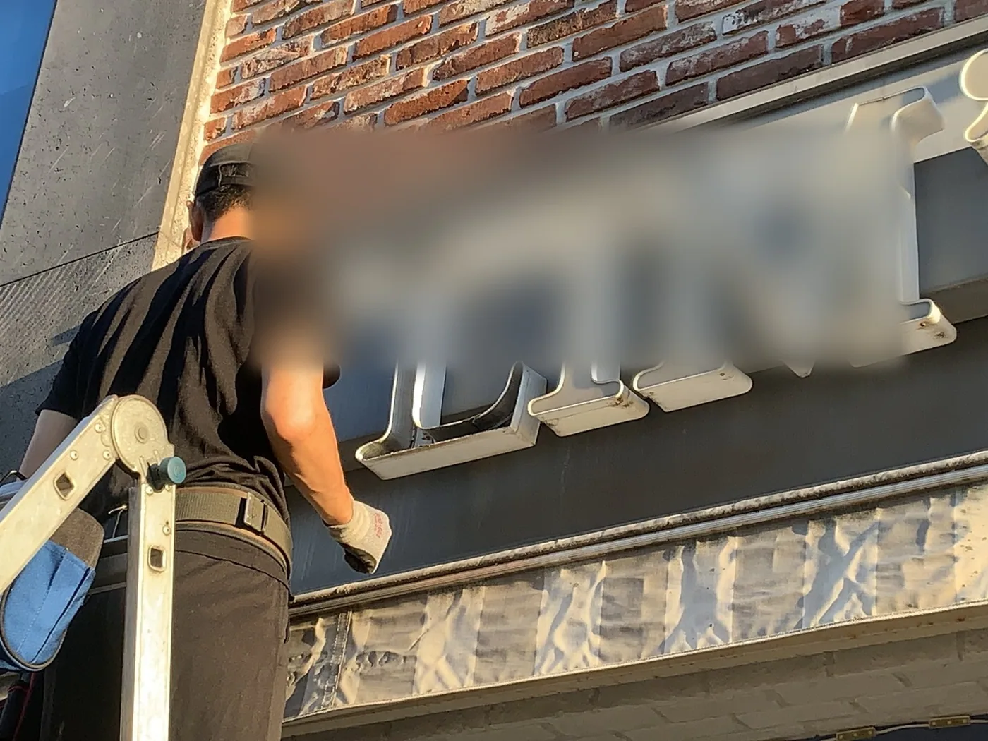 간판 바탕판 표면을 가까이서 담은 세척 작업 근접 장면